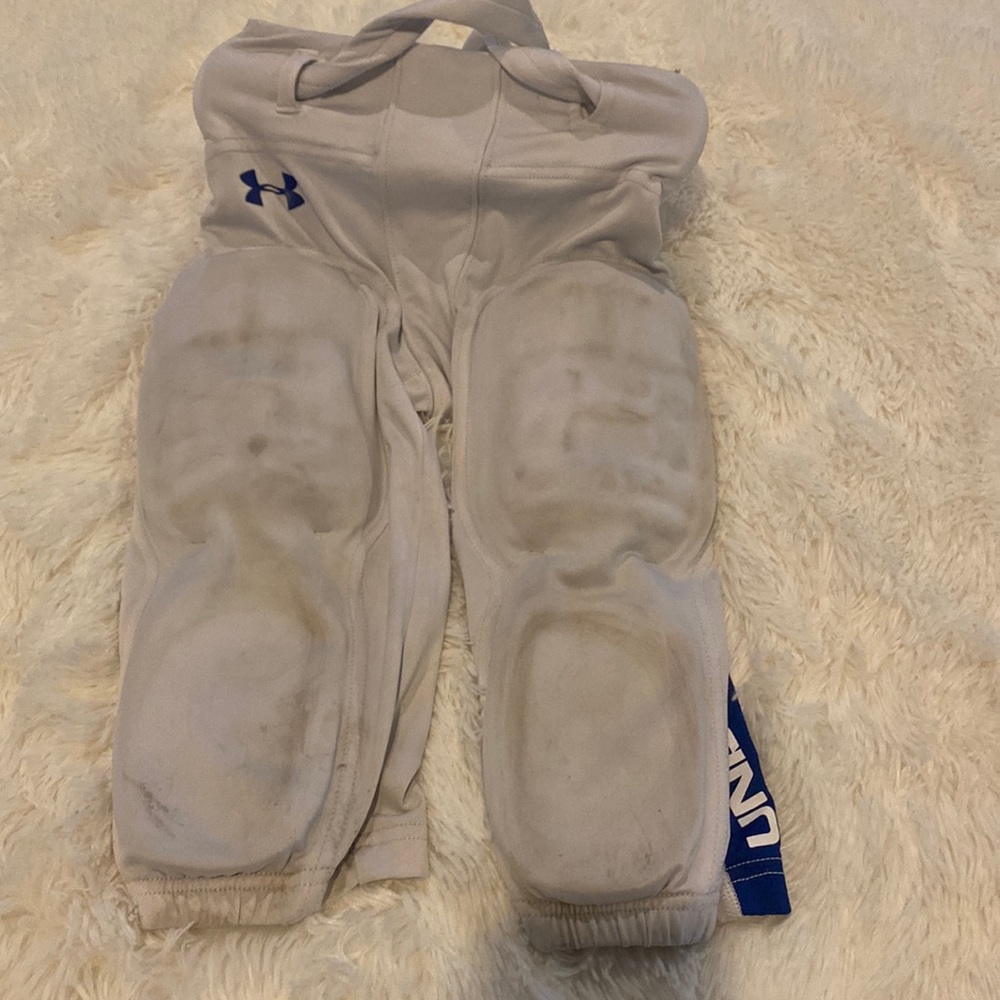 Medium under armor football pants with pads. Smoke free home.